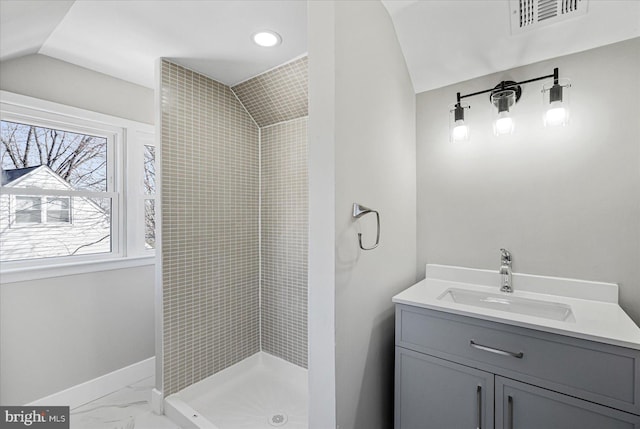 bathroom with vanity and a shower