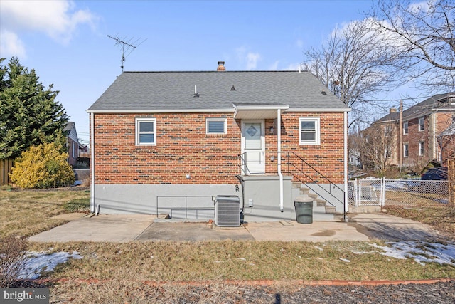 rear view of house with central AC and a patio