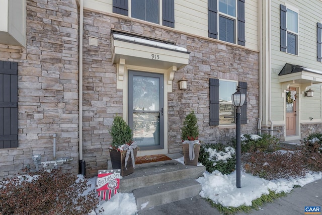 view of snow covered property entrance