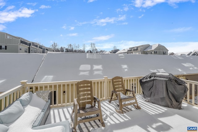 snow covered deck featuring a grill