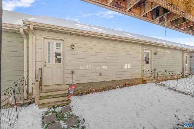 view of snow covered property entrance