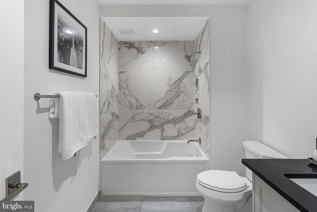 full bathroom with vanity, tiled shower / bath combo, and toilet