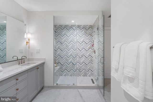 bathroom with tile patterned floors, vanity, and an enclosed shower