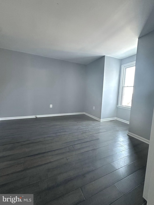 unfurnished room featuring dark hardwood / wood-style flooring