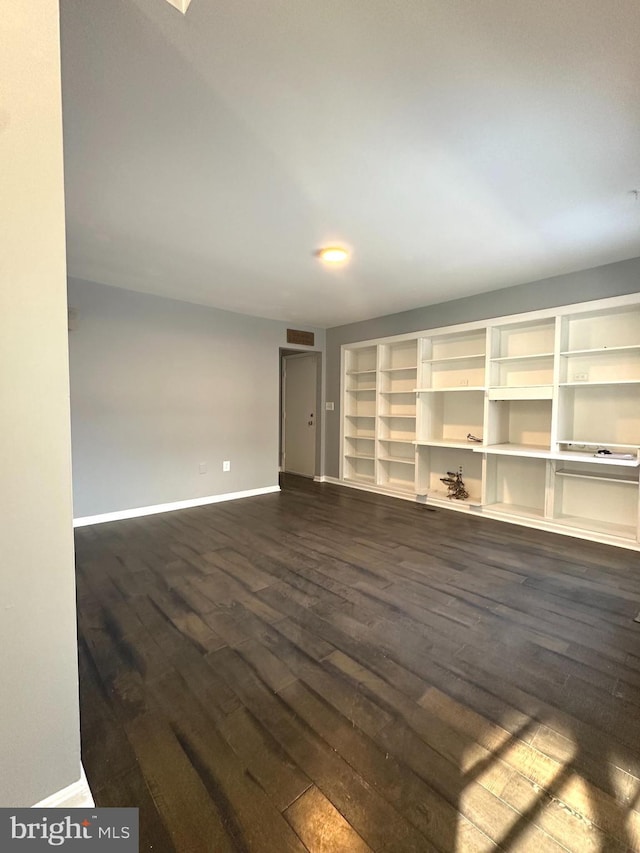 unfurnished room featuring dark wood-type flooring