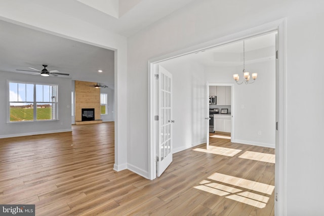 interior space featuring light hardwood / wood-style floors and a notable chandelier