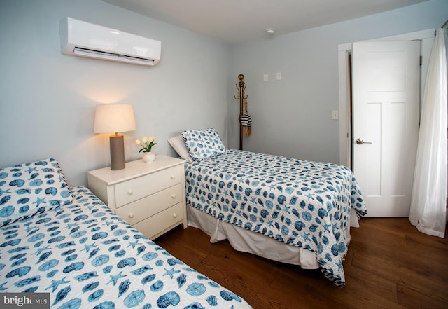 bedroom with an AC wall unit and dark hardwood / wood-style flooring