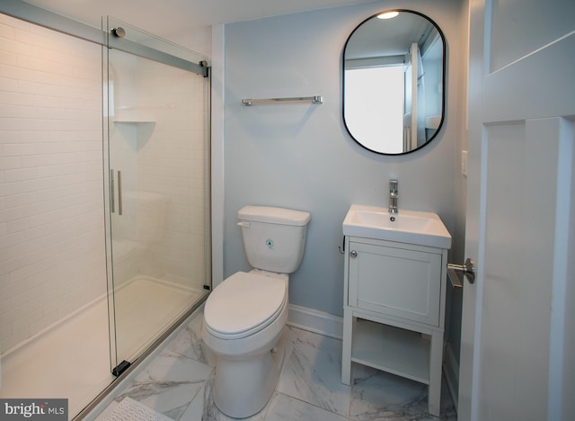 bathroom featuring vanity, toilet, and a shower with door