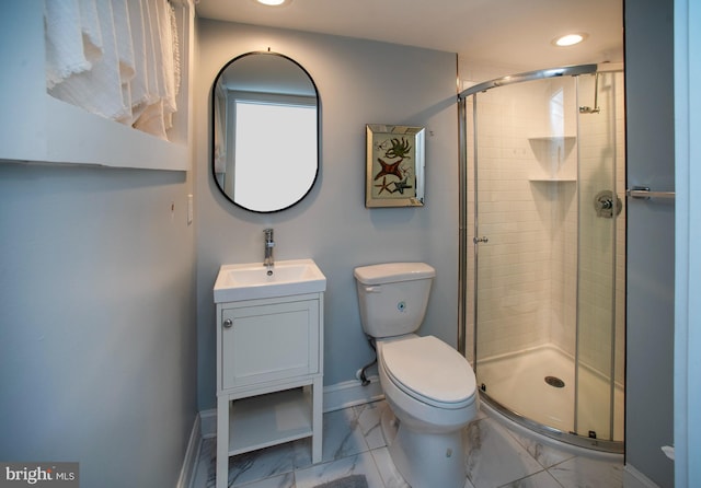 bathroom featuring toilet, a shower with door, and vanity