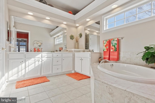 bathroom featuring tile patterned floors, tiled tub, and vanity