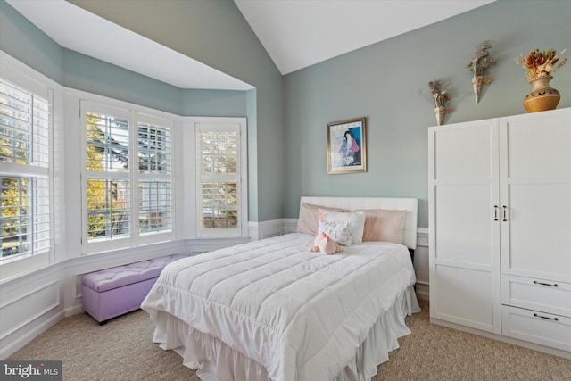 carpeted bedroom with vaulted ceiling