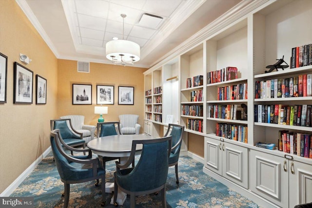 living area with ornamental molding and built in features