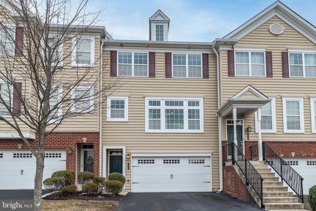 townhome / multi-family property featuring a garage