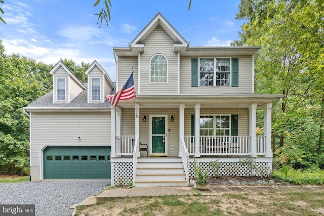 view of front of property featuring covered porch and a garage