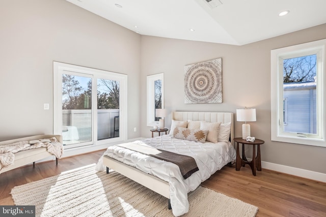 bedroom featuring hardwood / wood-style floors and lofted ceiling