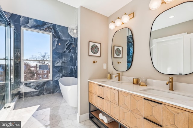 bathroom with a washtub and vanity