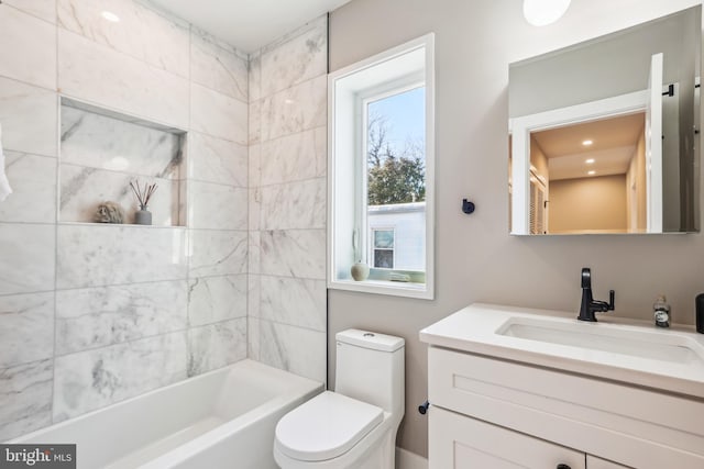 full bathroom with toilet, vanity, and tiled shower / bath combo