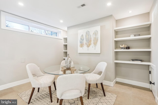 dining room featuring built in shelves