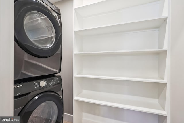 washroom featuring stacked washing maching and dryer