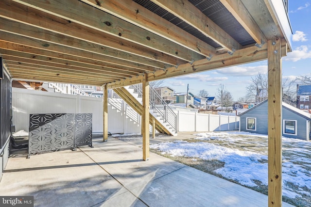 snow covered patio featuring an outdoor structure