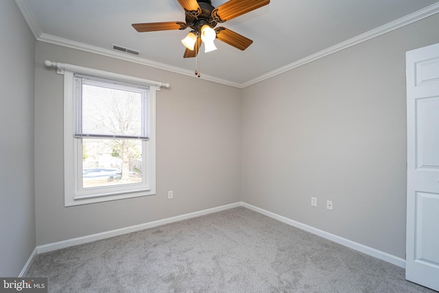 carpeted spare room featuring ornamental molding and ceiling fan