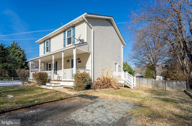 front facade with a front yard and a porch