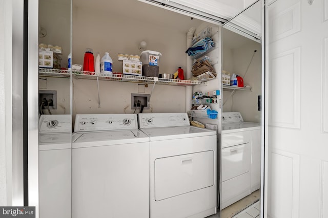 clothes washing area featuring washer and clothes dryer