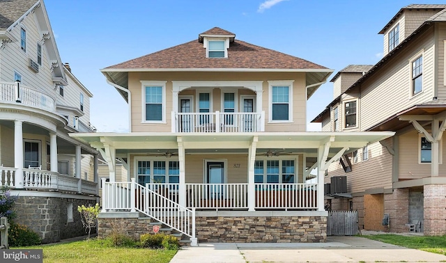 view of front of property featuring ceiling fan, a balcony, and covered porch