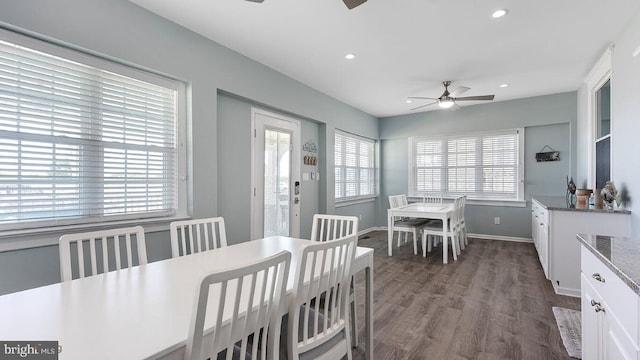 dining area with ceiling fan and dark hardwood / wood-style flooring