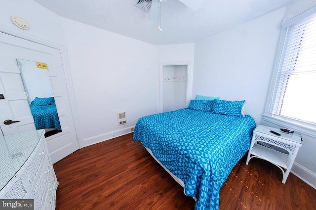 bedroom with dark wood-type flooring and ceiling fan