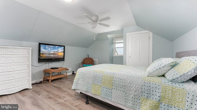 bedroom with lofted ceiling, hardwood / wood-style floors, and ceiling fan