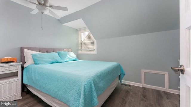 bedroom with dark hardwood / wood-style flooring, vaulted ceiling, and ceiling fan