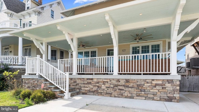 entrance to property featuring central AC, covered porch, and ceiling fan