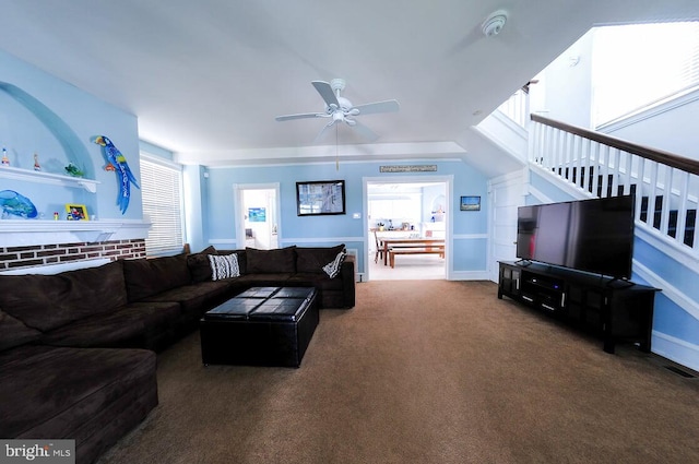 carpeted living room featuring ceiling fan