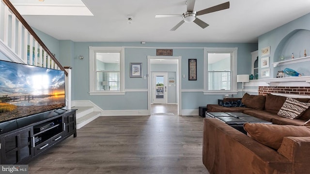 living room with dark wood-type flooring and ceiling fan