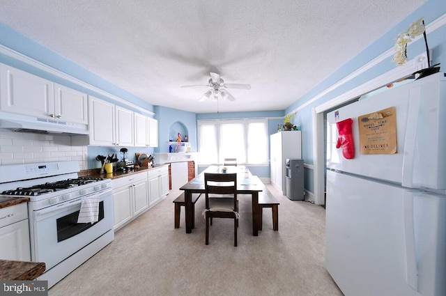 kitchen with tasteful backsplash, white appliances, a textured ceiling, and white cabinets