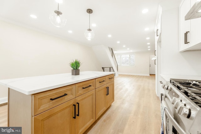 kitchen with pendant lighting, white cabinets, light wood-type flooring, white gas stove, and extractor fan