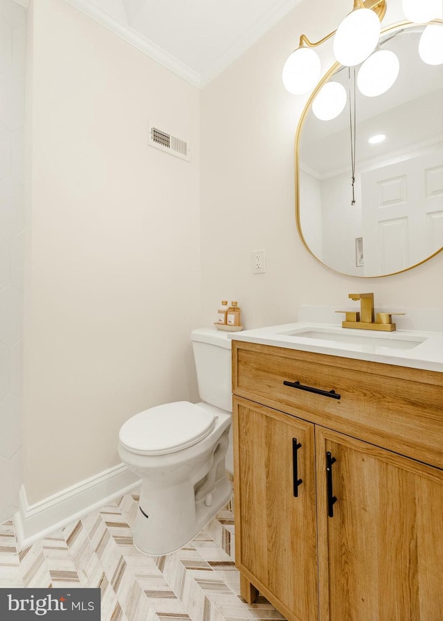 bathroom featuring vanity, toilet, and crown molding