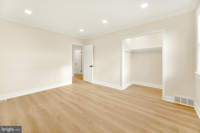 unfurnished bedroom with light hardwood / wood-style floors and a closet