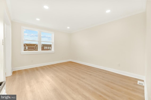 unfurnished room with light wood-type flooring and crown molding