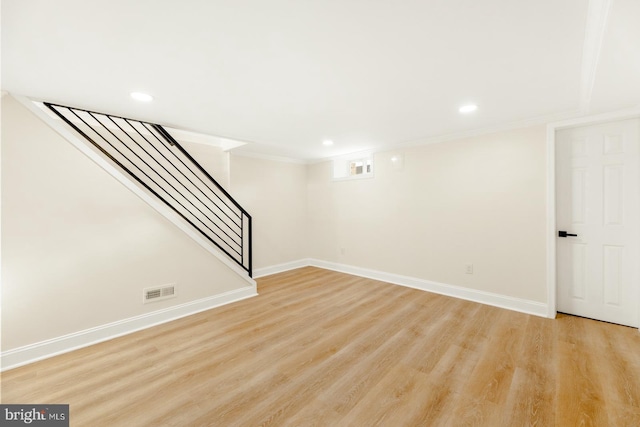 basement with light hardwood / wood-style floors