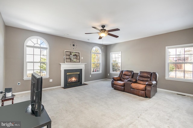 living room featuring ceiling fan and light colored carpet