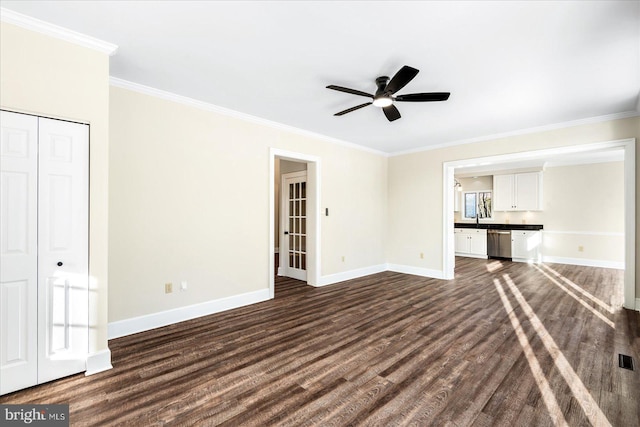 unfurnished living room with ornamental molding, dark wood-type flooring, sink, and ceiling fan