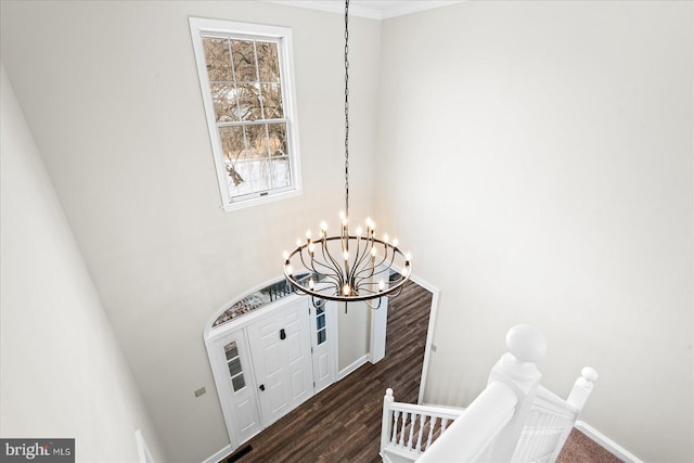 interior space featuring wood-type flooring and a notable chandelier