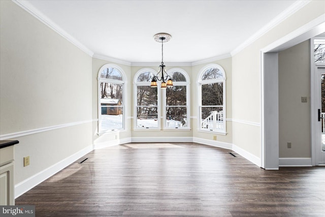 unfurnished dining area with crown molding, dark wood-type flooring, and a chandelier