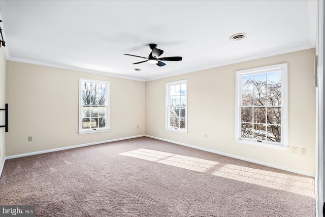 carpeted spare room with ornamental molding and ceiling fan