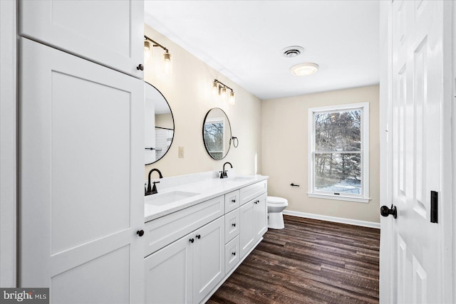 bathroom featuring vanity, toilet, and hardwood / wood-style floors