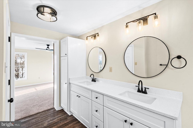 bathroom with ceiling fan, vanity, and hardwood / wood-style floors