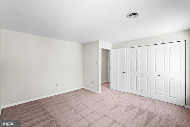 unfurnished bedroom with carpet and a closet