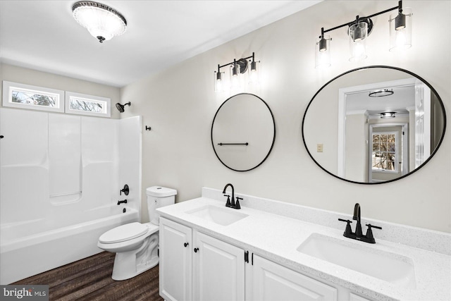 full bathroom with vanity, hardwood / wood-style flooring, tub / shower combination, and toilet